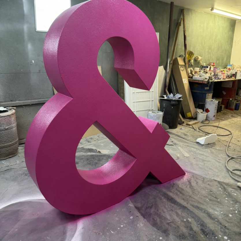 large 3d pink ampersand sign